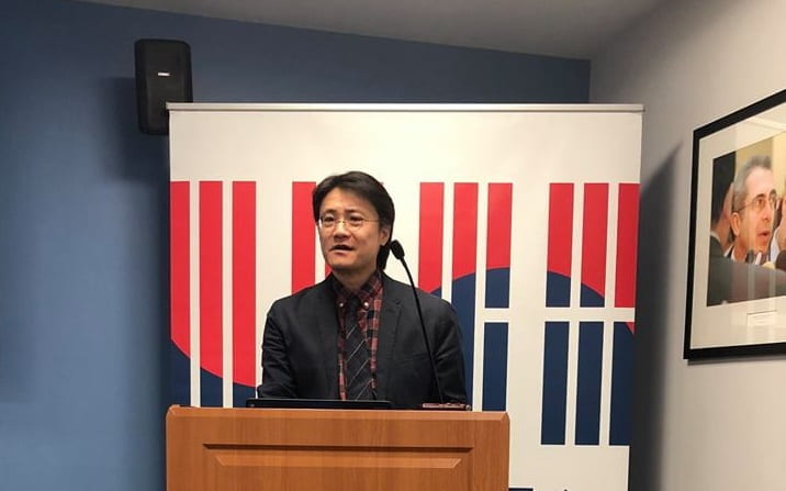 Taekyoon Kim speaking at a GWIKS lecture series event at a podium