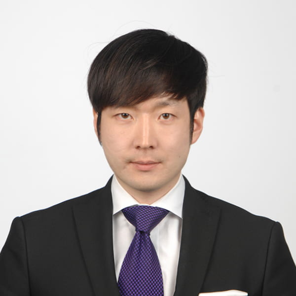 headshot of Jungho Suh in professional attire