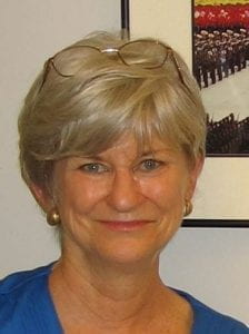 headshot of Christy Gavitt with photo frame behind her