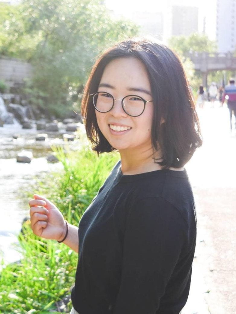 Ru Kim posing for photo next to a canal in the city under the sun