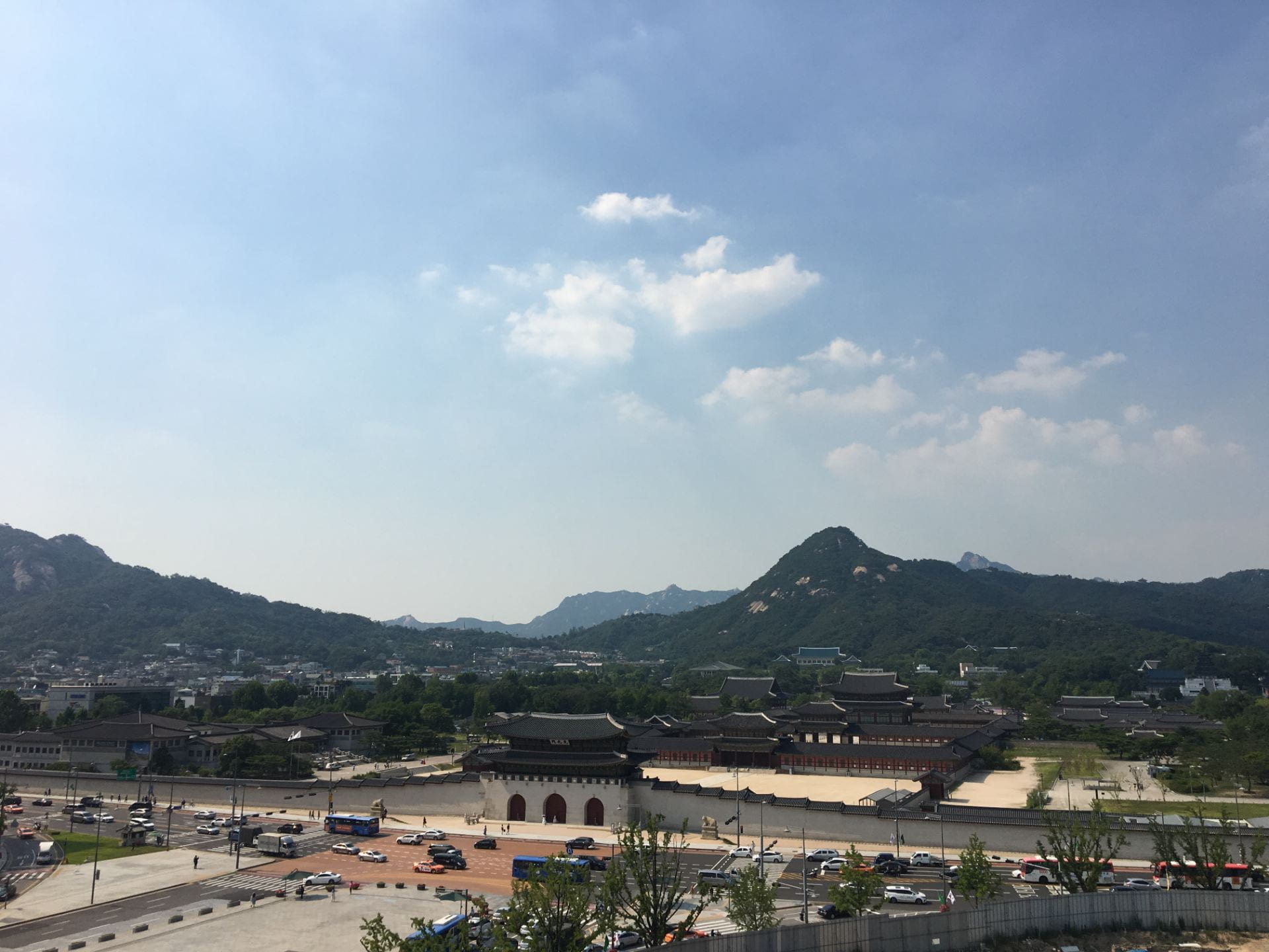 aerial view of a palace in South Korea with mountains in the background