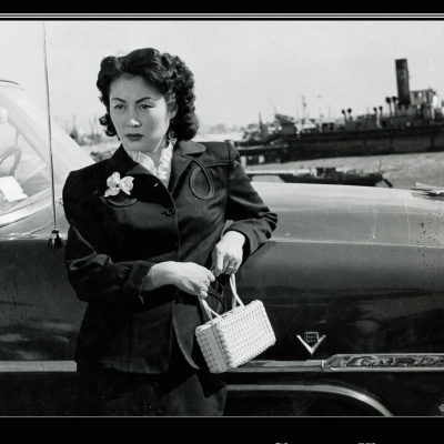 Korean woman in the 1950s leaning against car
