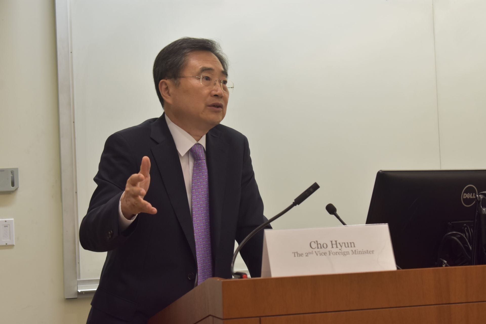 Cho Hyun speaking at the podium at an event